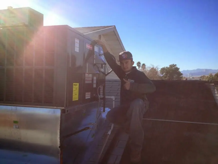 HVAC technician performing HVAC Inspection on a rooftop unit in Detroit
